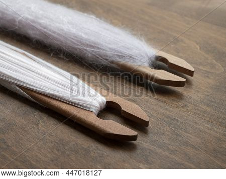 Soft Pale Pink Woolen Yarn On The Weaving Shuttles, Close Up. Tools For Weaving With A Loom