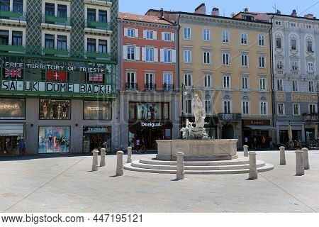 Trieste, Italy - June 17, 2019: Ancient Fountain Di Nettuno In Piazza Della Borsa In Trieste With Sh