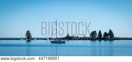 Broadside View Of Sailboat Moored In Marina At Grand Marais In Northern Minnesota On A Sunny Morning