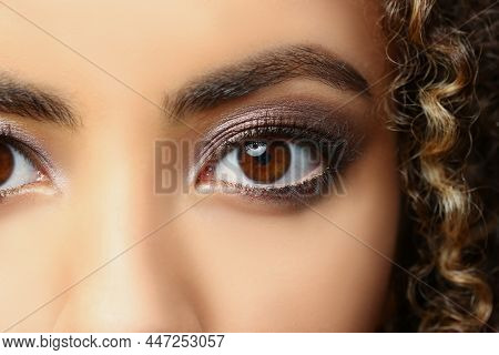 Close-up Of Latino American Beautiful Woman With Brown Eyes, Curly Hairstyle Posing For Picture. Att