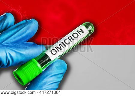Indonesia Outbreak Of Omicron Variant. A Hand In A Blue Rubber Glove Holds A Test Tube With Covid-19