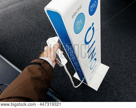 Vendenheim, France - Nov 14, 2021: Male Hand Taking Plug On The Ioniq Supercharger Ev With Logotype 
