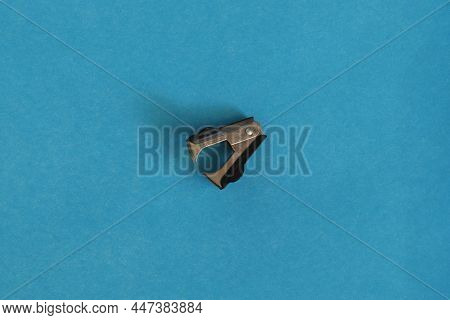 Stationery, Anti Stapler On A Blue Background. Office Items