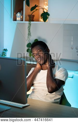 Exhausted African American Tired Stressed Man Suffer From Neck Pain. Male Touching Massage Neck Sit 