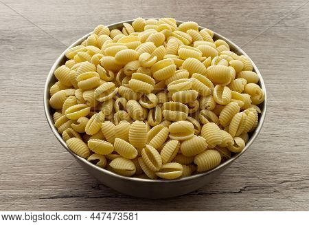 Raw Italian Gnocchetti Sardi Pasta On Wooden Table.