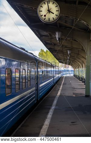 Saint Petersburg, Russia - 27.08.2020 Vintage Iron Platform With Clock, Railway Station With Blue Tr