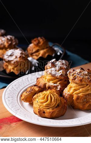Food Concept Homemade Caramel Choux A La Cream Or Choux Cream Puffs On Dark Background With Copy Spa