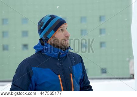 Portrait Of A Builder In A Blue Knitted Hat And Blue Winter Jacket