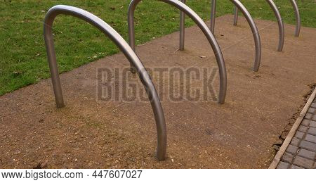 Metal Cycle Rack Or Stands On Hardstanding Beside Grass Lawn