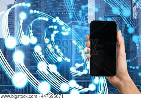 Close Up Of Hand Holding Empty Mock Up Smartphone With Creative Circular Light Blurry City Backgroun