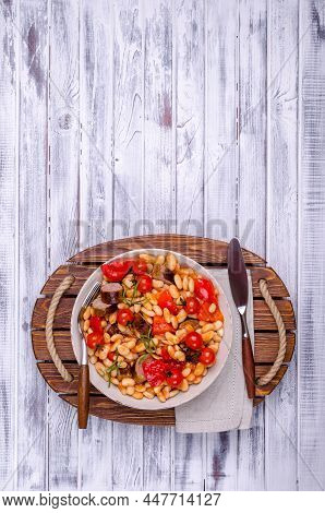 Braised Beans With Vegetables And Fried Sausages On A Wooden Background. Top View.