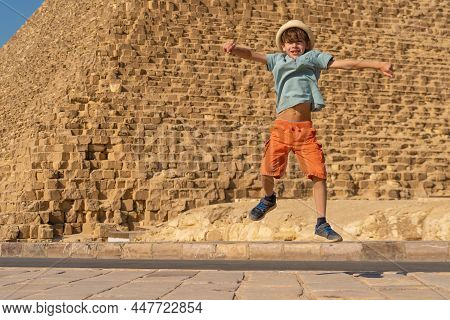 Happy Boy Jumping In Front Of The Cheops Pyramid On The Giza Plateau