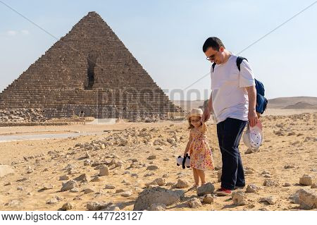 Father With Daughter Walking In Front Of The Pyramid Of Mikerin On The Giza Plateau