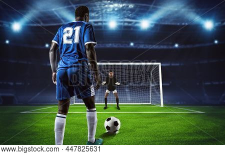 Soccer Scene At Night Match With Player In Blue Uniform Kicking The Penalty Kick