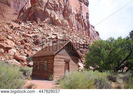 The Tiny Small Fruita Schoolhouse With The Red Rock Cliff On The Back In Utah