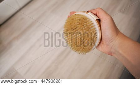 Female Hand Is Holding Hatural Wooden Body Brush. Massage, Relax, Spa. Eco-friendly, Zero Waste Prod