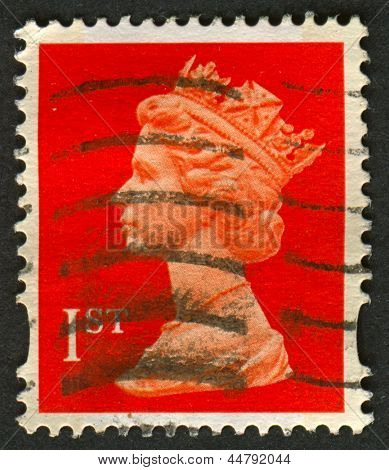 UK-CIRCA 1990:A stamp printed in UK shows image of Elizabeth II is the constitutional monarch of 16 sovereign states known as the Commonwealth realms, in red, circa 1990.