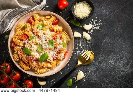 Traditional Italian Pasta With Tomato Sauce, Basil And Parmesan On Black Table. Fusilli Pasta With T
