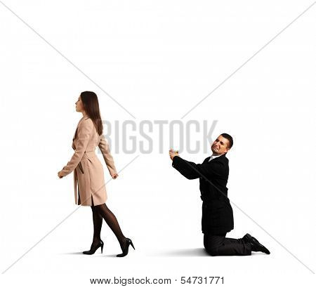 sad man bending the knee before outgoing woman. isolated on white background