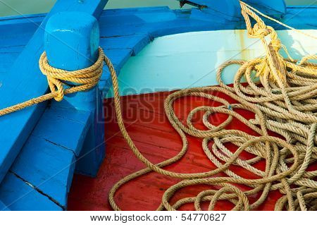 Marine Rope Tied Around The Boat's Pole With Lots Of Spare Length On The Boat's Deck