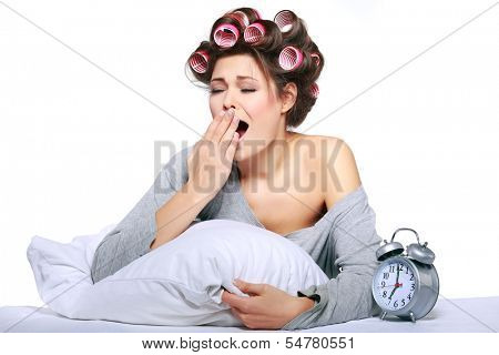 happy positive young  woman waking up and switching off the alarm clock