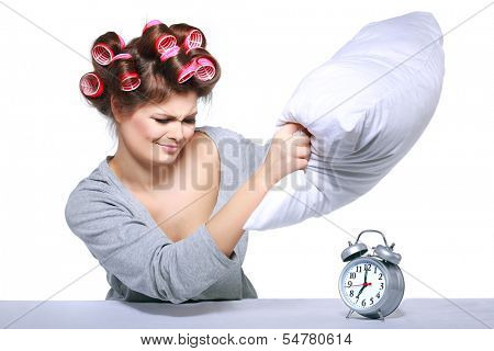 happy positive young  woman waking up and switching off the alarm clock