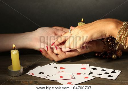 reading the lines hand in a woman's hands on grey backcground