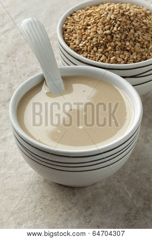  Bowls with tahini paste and roasted sesame seeds 