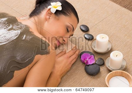 Relaxed Woman Receiving A Mud Treatment At Spa