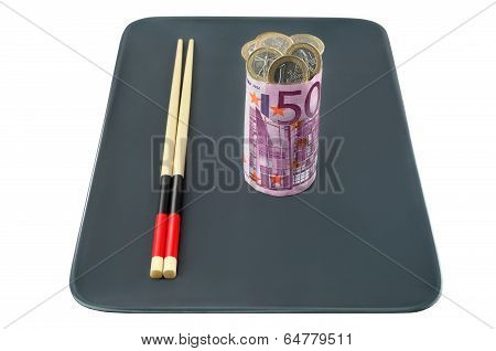 Sushi of euro banknotes stuffed with coins on a plate for use in the business.