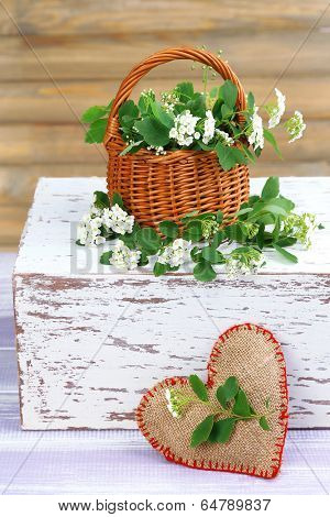 Beautiful spirea flowers on wooden table, close up
