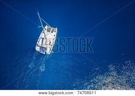 Amazing view to Catamaran cruising in open sea at windy day. Drone view - birds eye angle