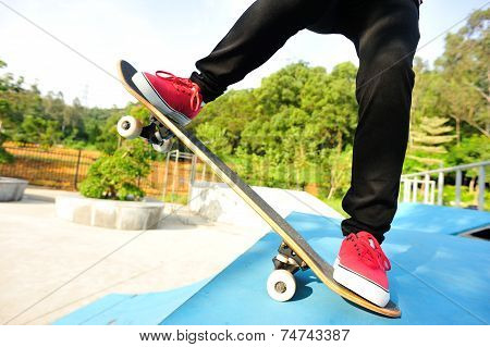 woman skateboarder skateboarding at skate park