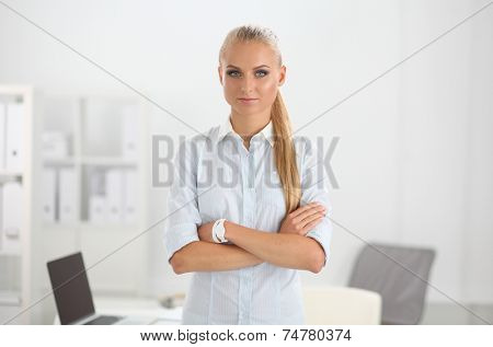 Attractive businesswoman with her arms crossed stnding