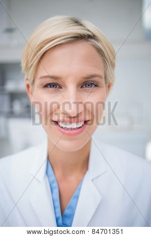 Close-up portrait of confident female doctor smiling in clinc
