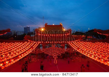 KUALA LUMPUR, MALAYSIA - FEBRUARY 23, 2015: Tourists visit the scenic Thean Hou Temple at night with hundreds of lanterns hung across the courtyard celebrating the lunar Chinese New Year.
