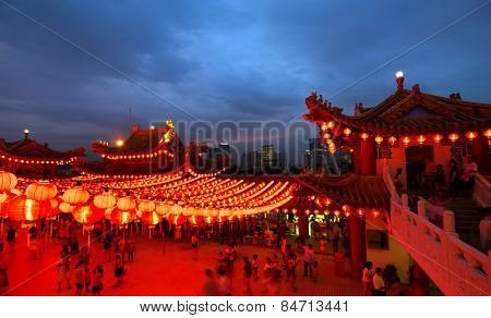 KUALA LUMPUR, MALAYSIA - FEBRUARY 23, 2015: Tourists visit the scenic Thean Hou Temple at night with hundreds of lanterns hung across the courtyard celebrating the lunar Chinese New Year.