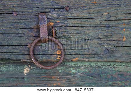 Rusty ring pull on shed door.