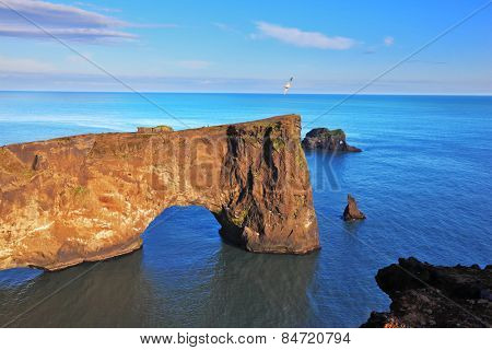 Cape Dyrholaey in southern Iceland. Sunset in July. The colossal rock in the sea in the form of an elephant