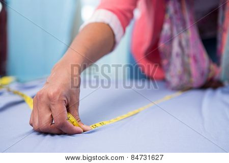Mid section of female fashion designer at work