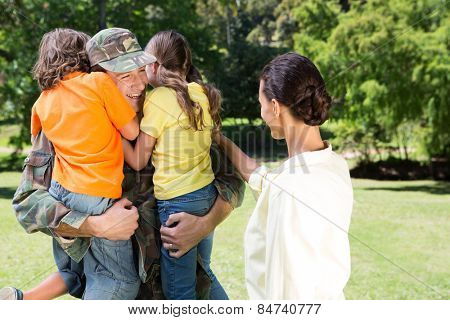 Handsome soldier reunited with family on a sunny day