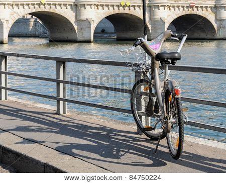 PARIS, FRANCE - CIRCA AUGUST 2009: A Velib' next to the river Seine. Velib' is a public bicycle sharing scheme