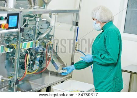 pharmaceutical factory woman worker operating production line at pharmacy industry manufacture factory