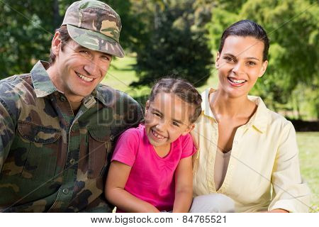 Handsome soldier reunited with family on a sunny day