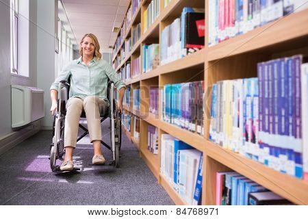 Smiling disabled student in library at the university