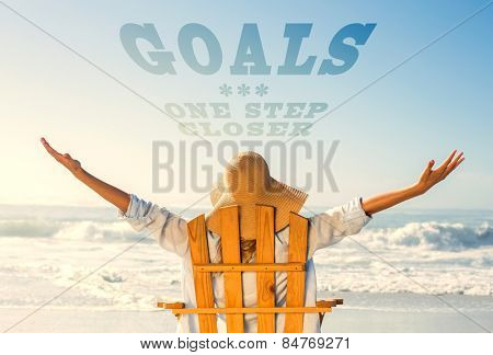 Woman relaxing in deck chair by the sea against goals one step closer