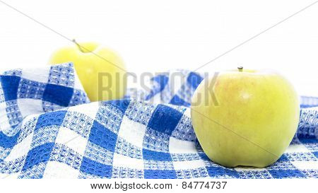 Fresh Yellow Apple Healthy Fruit On Folded Blue Tablemat