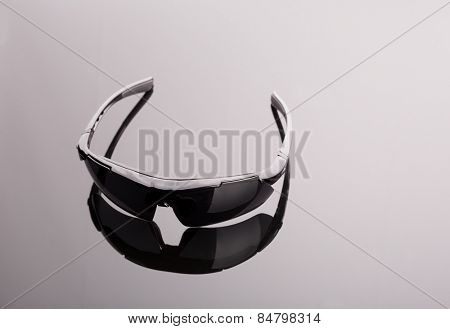 Black sunglasses on grey
