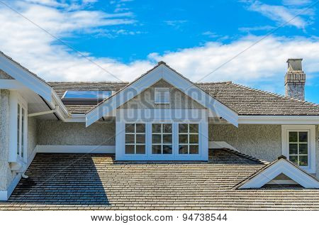 The roof of the house with nice window.