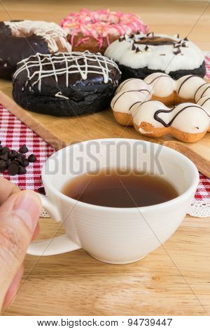 Hand Holding Cup Of Coffee During Doughnut Or Donut Coffee Break
